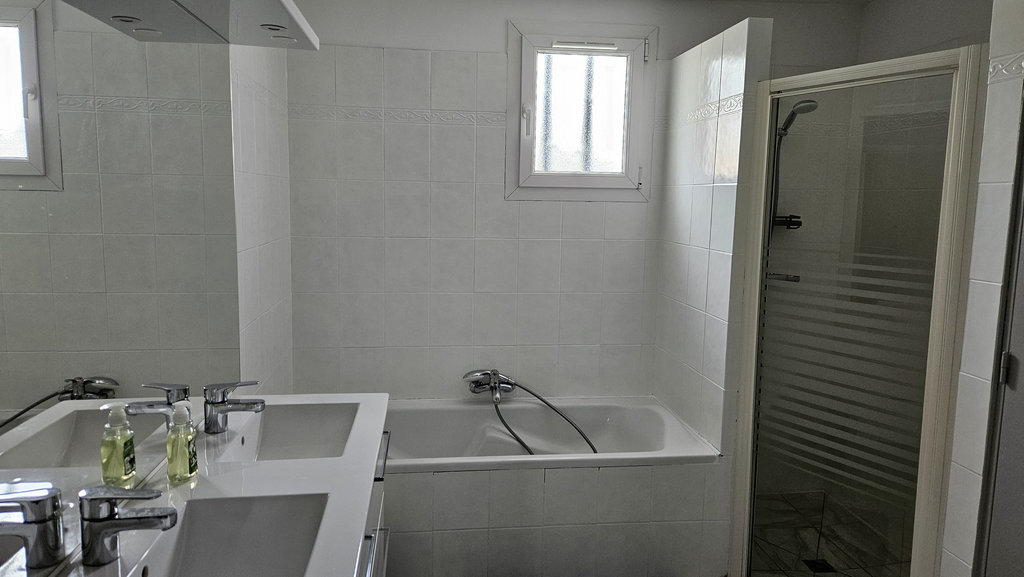 The bathroom with a double basin, bath and shower