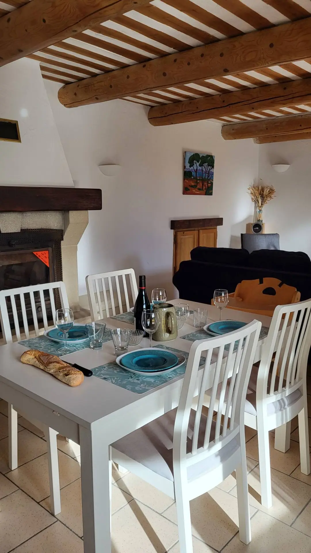 The laid table in front of the fireplace, with the sofa in the background