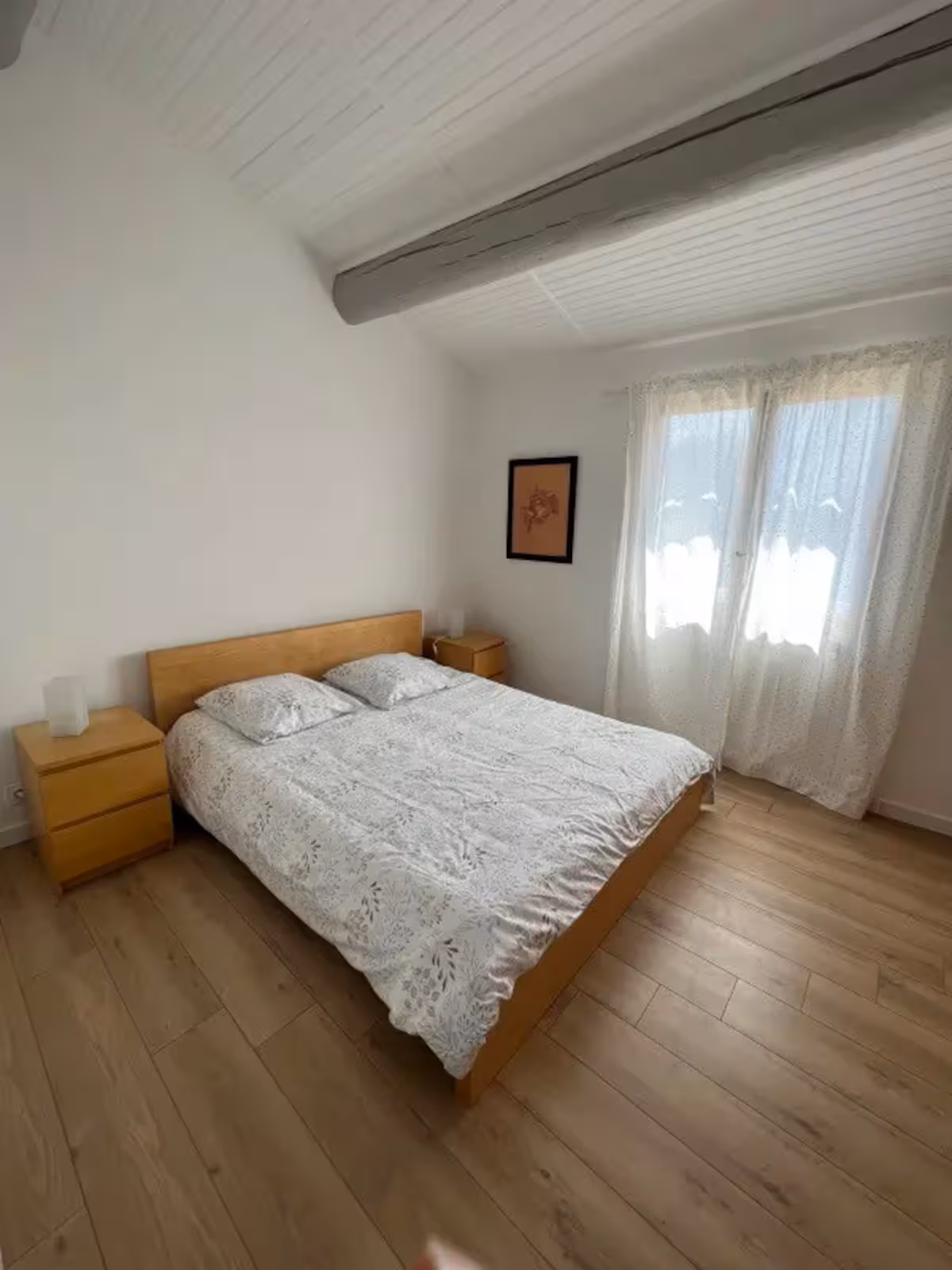 A bedroom with a wooden double bed