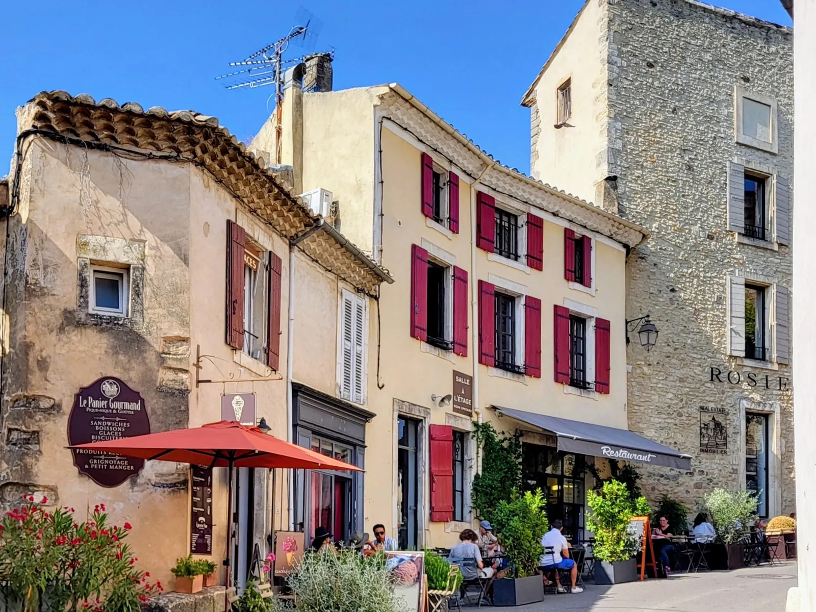 A lane in Gordes, with its red-shuttered façades and café terraces
