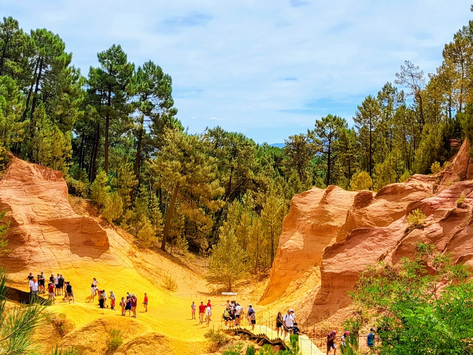 The Roussillon ochre trail between orange cliffs and pines